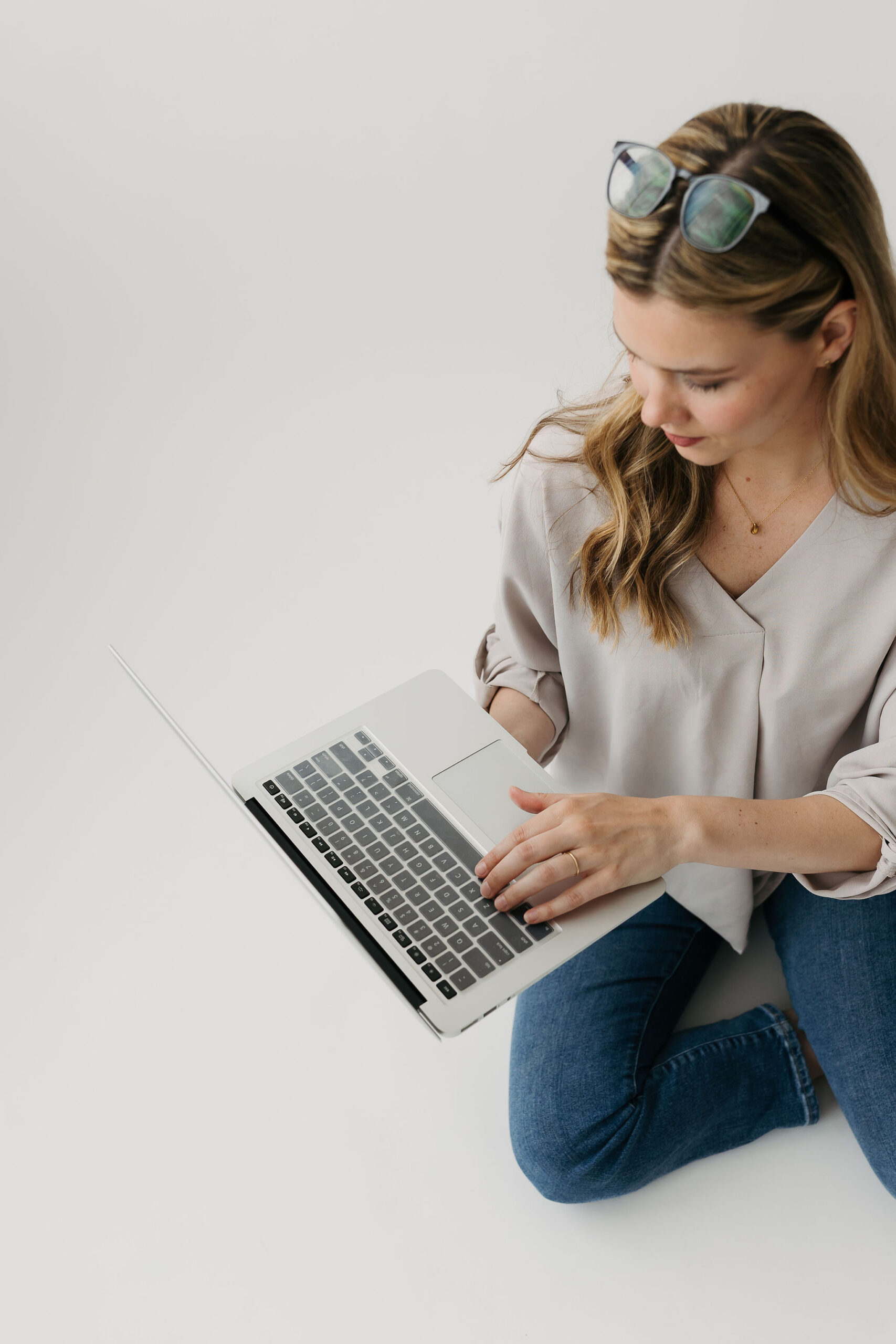 women looking at laptop on the floor