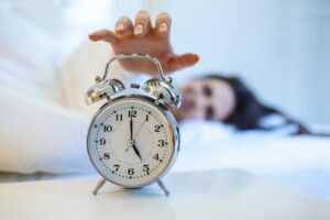 A woman beside a clock